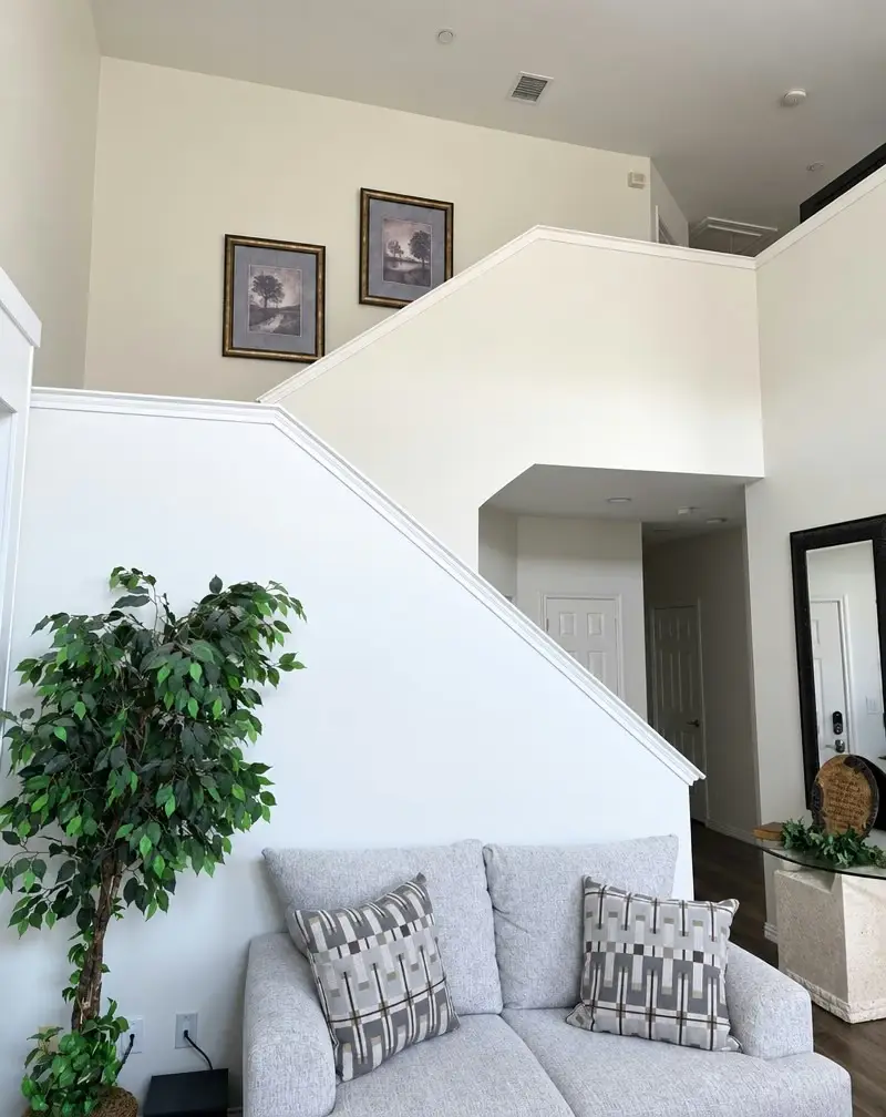 Dated builder-grade staircase before remodel